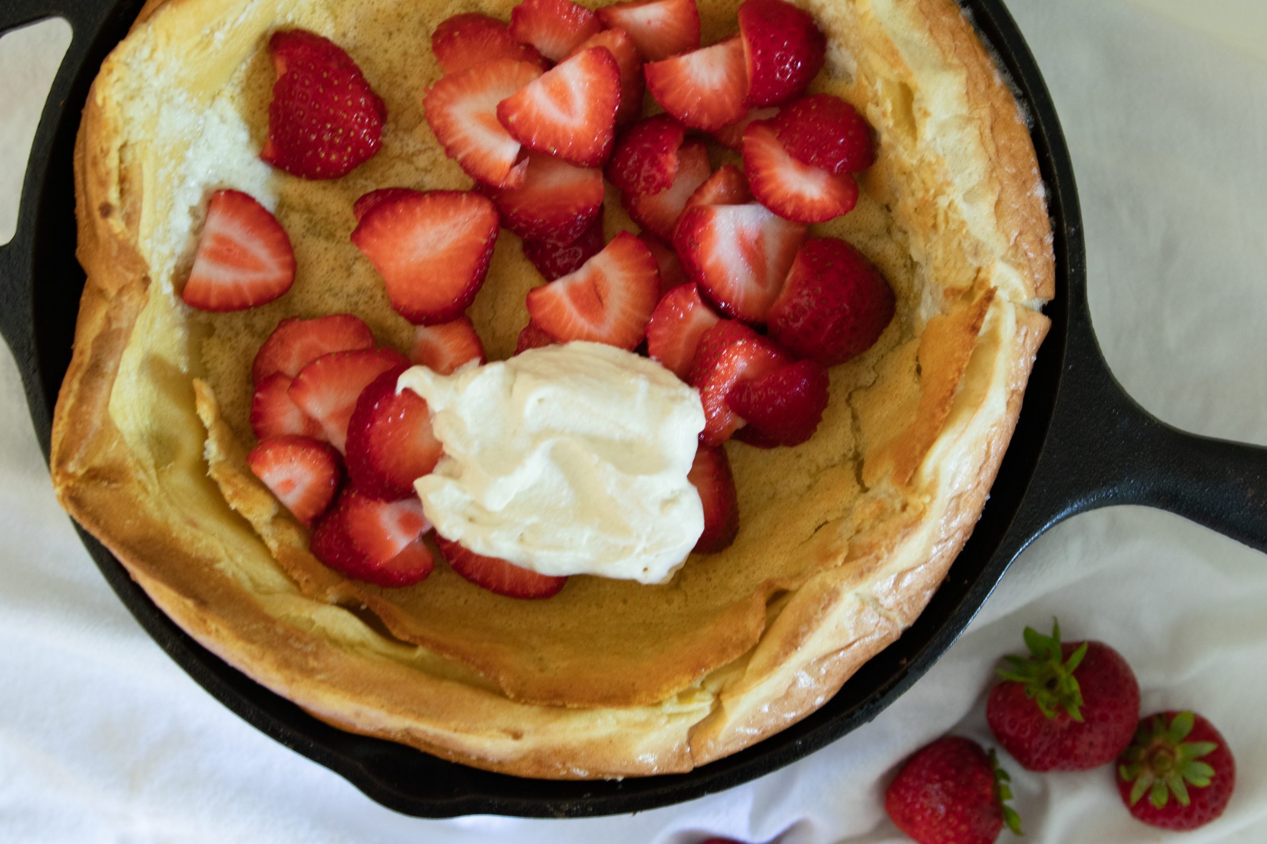 dutch baby with strawberries and whipped cream
