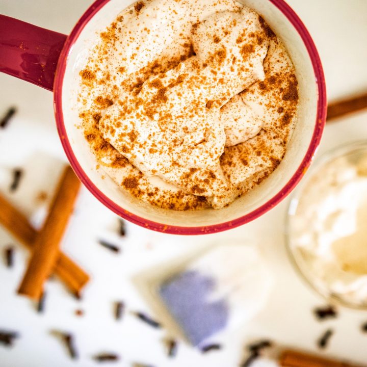 cup of christmas morning chai with chai spiced whipped cream