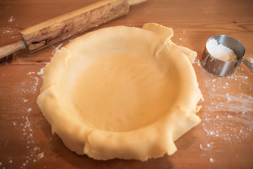 sourdough pie crust draped over pie plate