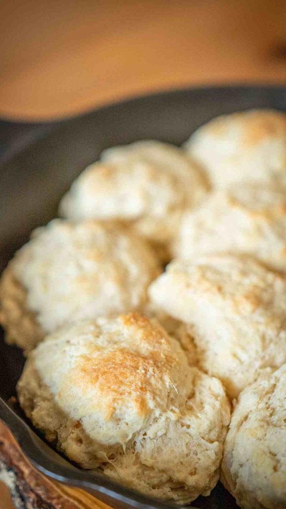 close up of sourdough buttermilk biscuits in a cast iron pan