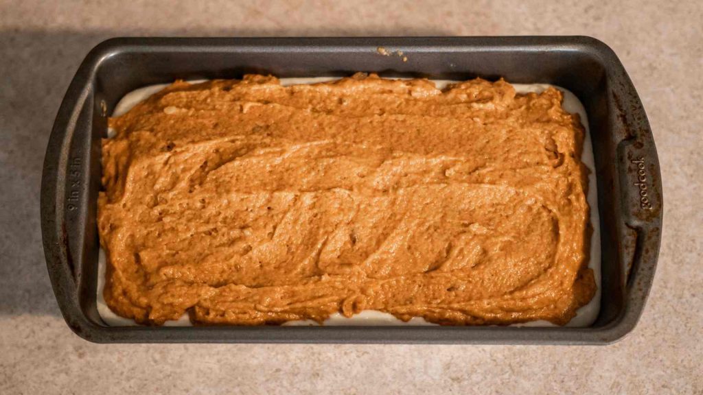 pumpkin sourdough bread batter in a loaf pan ready to bake