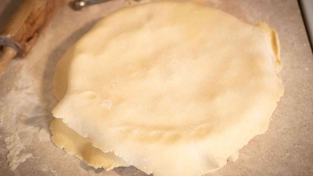 unbaked sourdough pie crust draped over chicken pot pie