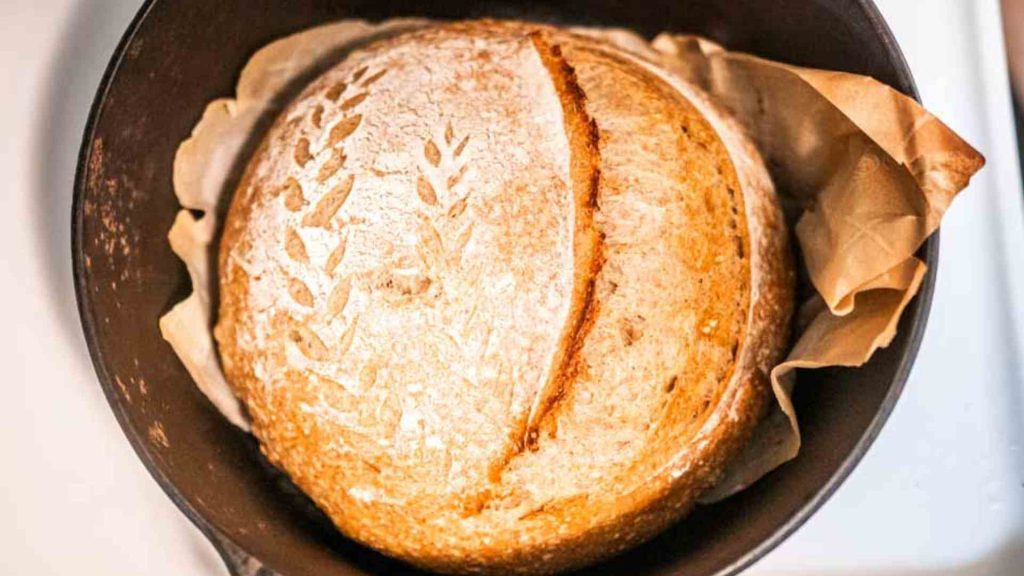 a beautiful loaf of sourdough bread in a dutch oven
