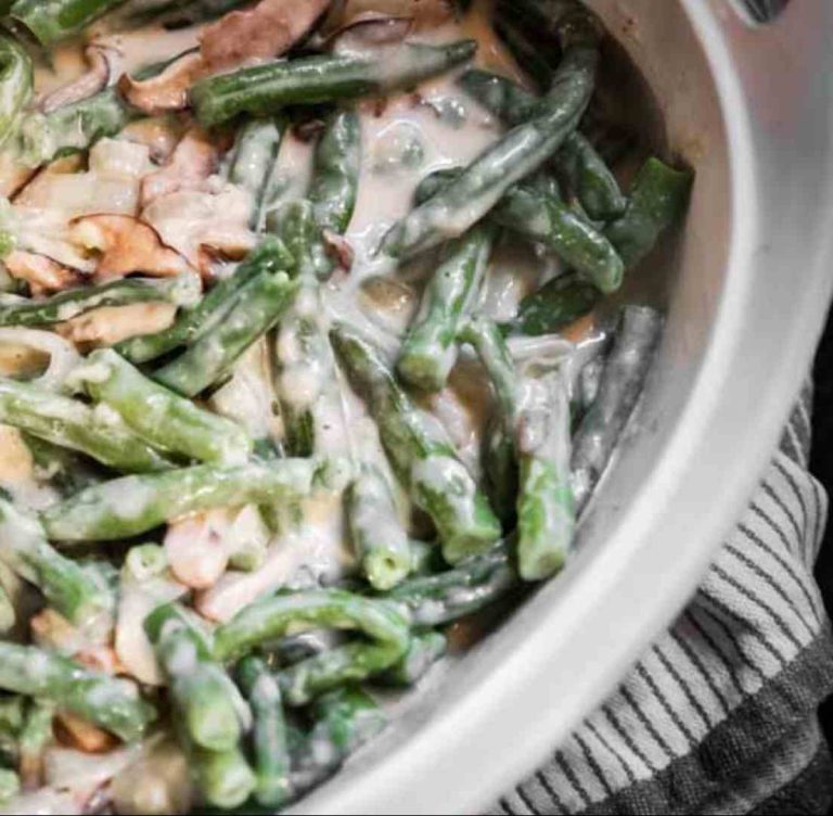 blanched green beans with mushroom sauce on top in a casserole dish
