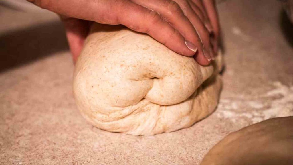 hands shaping the dough by rolling it up