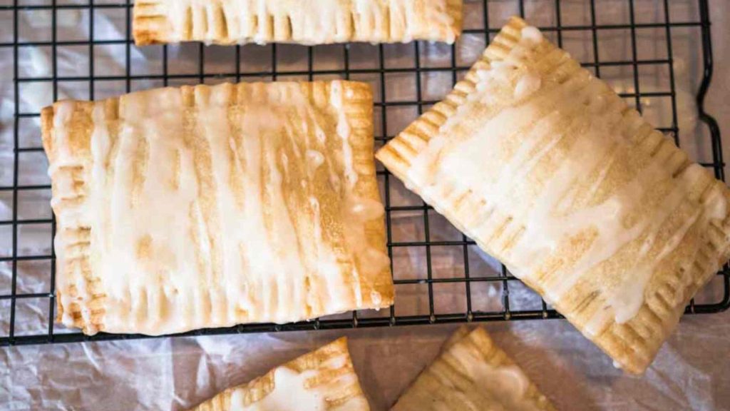 sourdough pop tarts drizzled with sweet glaze on a cooling rack
