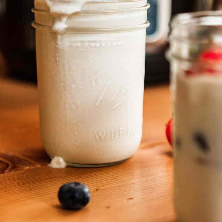 jar of raw milk yogurt with fresh berries