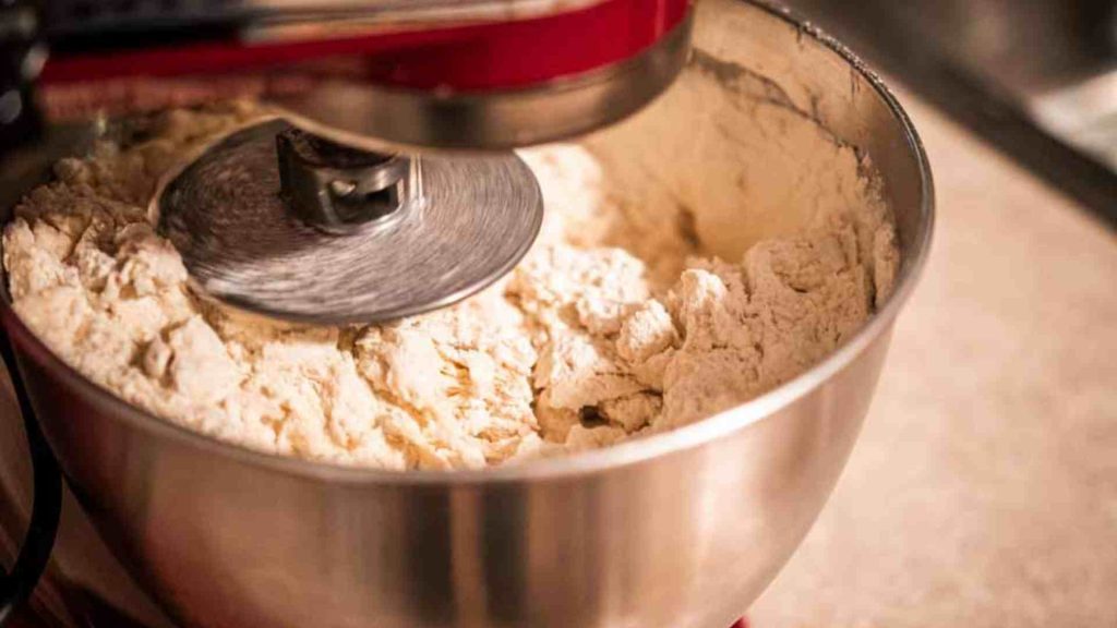 a kitchenaid stand mixer mixing soft sourdough bread dough