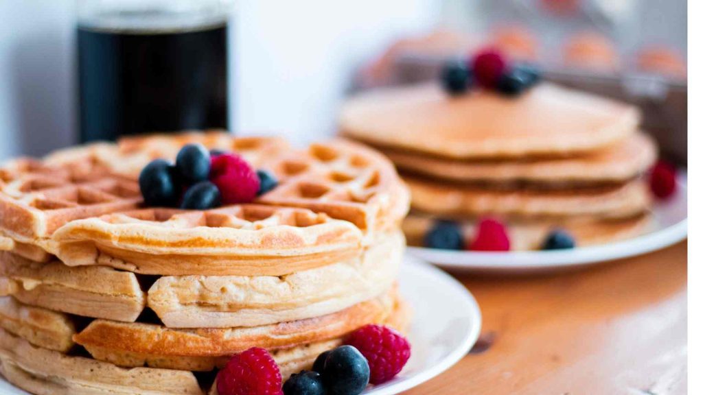 classic sourdough pancakes or waffles with berries and maple syrup