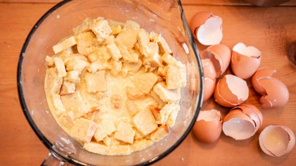 eggs, milk, butter and sourdough bread cubes in a mixing bowl