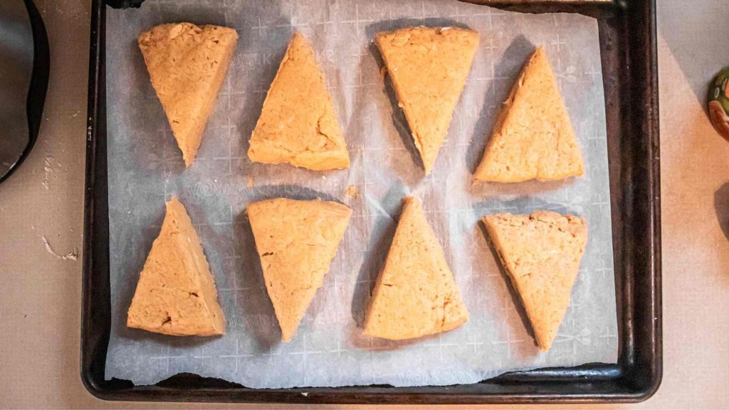pumpkin sourdough scone dough arranged on a baking sheet