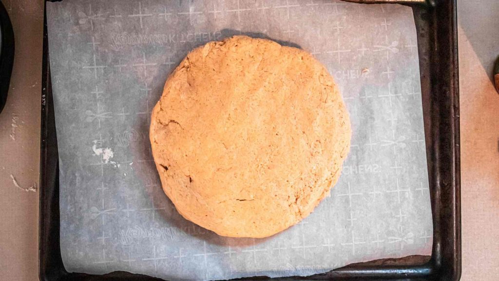pumpkin sourdough scone dough shaped into a circle 