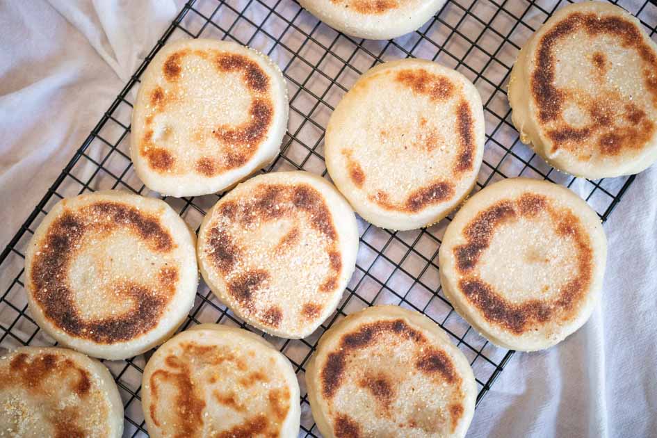 finished sourdough english muffins on a wire cooling rack